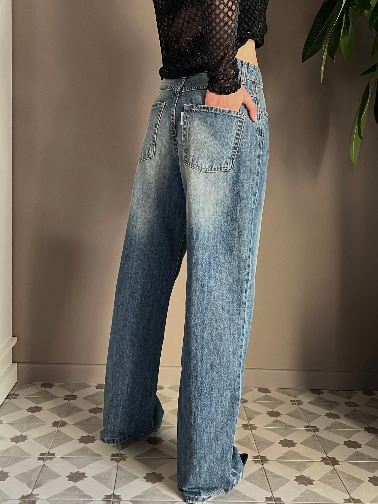 Pantalone in denim con strappo sul fondo